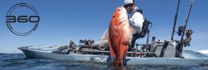 Man in kayak holding a Snapper